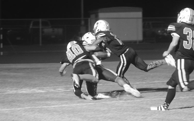 Braylon Johnson (40) and Jayland Duplechin (13) combine for a tackle on a Crowley player near the goal line in Pine Prairie’s 48-0 loss Thursday night at home. (Gazette photo by Tony Marks)