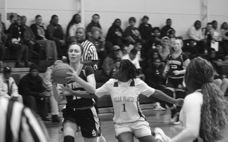 Britelah Freeman (1) attempts to steal the ball away from Jolie Redmon (10) in Ville Platte’s district opening win over Pine Prairie. (Gazette photo by Tony Marks)