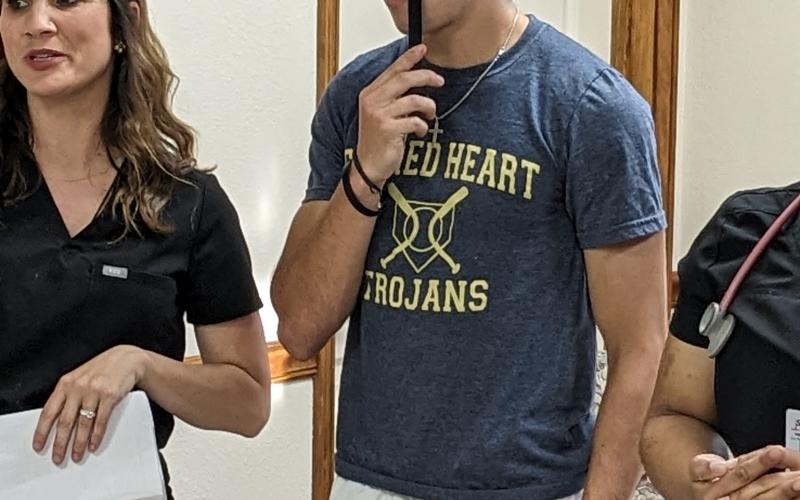 Dr. Ginger Delafosse (left) performs a vision test on senior Sacred Heart Trojan Landon LeBlanc (right) during the annual high school physicals at Healthworks Rehab. (Gazette photo by Rhett Manuel)
