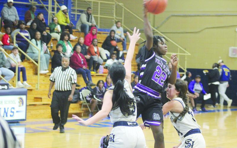 Brileyah Freeman (22) looks to pass the basketball to a Lady Bulldog teammate while being defended by Sacred Heart’s Olivia Tate (13) and Riley St. Cyr (34) in Ville Platte’s 51-38 win to open up the parish tournament.