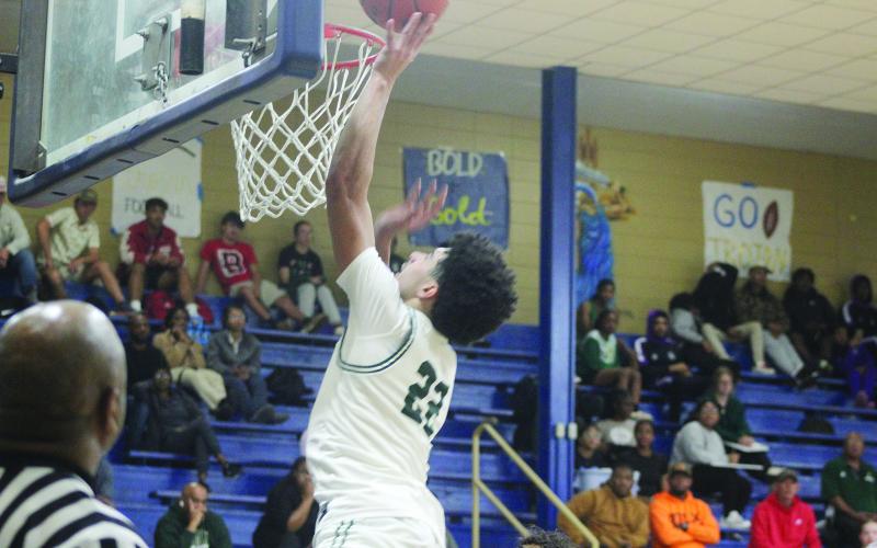 Shay Collins, who scored 12 points for Mamou, goes up for a basket in the Green Demons’ 76-26 win over the Basile Bearcats to close out the first day of the tournament. (Gazette photos by Tony Marks)