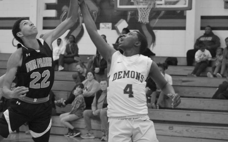 Mamou’s Dezmond Skinner (4) is pictured as he comes down from making a basket against Pine Prairie. Also pictured is Pine Prairie’s Isiah Bourque (22). (Gazette photo by Tony Marks)