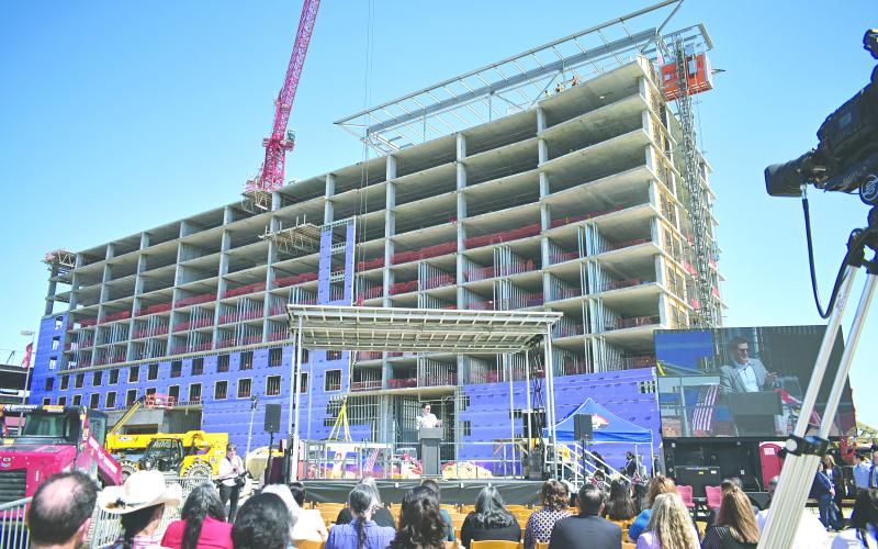 In the left photo, guests watch as the final beam was installed on the construction site of the new hotel being built at Coushatta Casino Resort.
