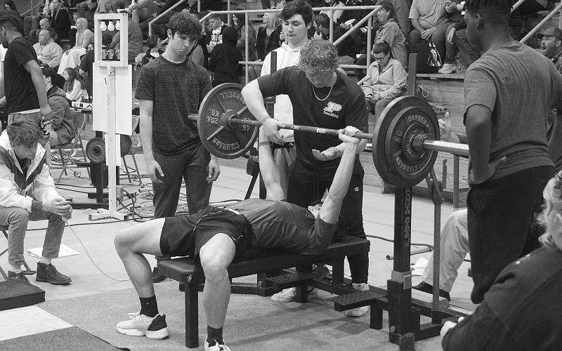Chase Holsomback, of Pine Prairie High School, bench presses in the Sacred Heart Invitational. His best mark in the event was 215 pounds, and his total mark on the day in all three events was 915 pounds. (Gazette photo by Tony Marks)