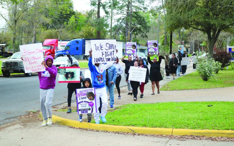 The peaceful protestors are pictured as they circle around the Evangeline Parish Courthouse seven times on Monday, March 11. The event was held in memory of Brittany Fontenot. (Gazette photo by Tony Marks)