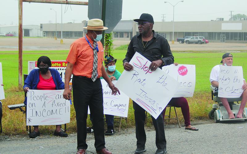 Ville Platte City Councilman Lionel Anderson (left) discusses issues with one of the protest organizers Donald Anderson (right) at the event held outside of the Cleco office in Ville Platte. (Gazette photo by Tony Marks)