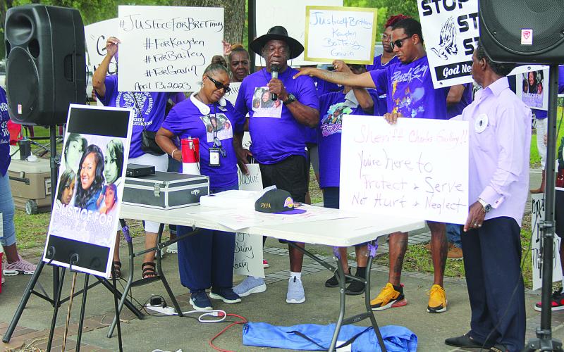 Pictured in the center is Charles Malveaux, the father of Brittany Fontenot, as he addressed the gathering. On his right is Brittany’s mother, Yvonne. (Gazette photo by Tony Marks)