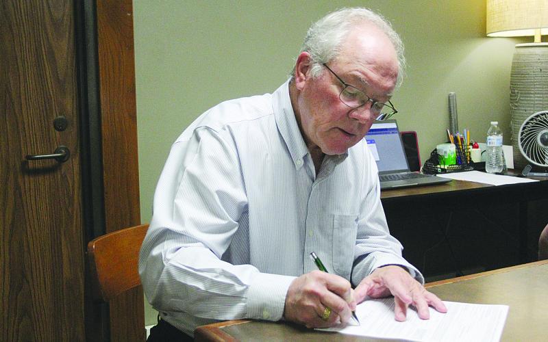 Evangeline Parish Clerk of Court Randy Deshotel was the first person to qualify for the upcoming October elections. Qualifying began on Tuesday, August 8, and runs will end today, August 10, at 4:30 p.m. Deshotel is seeking his fourth term as clerk and is pictured as he signs the form which will be sent to the secretary of state’s office. (Gazette photo by Tony Marks)