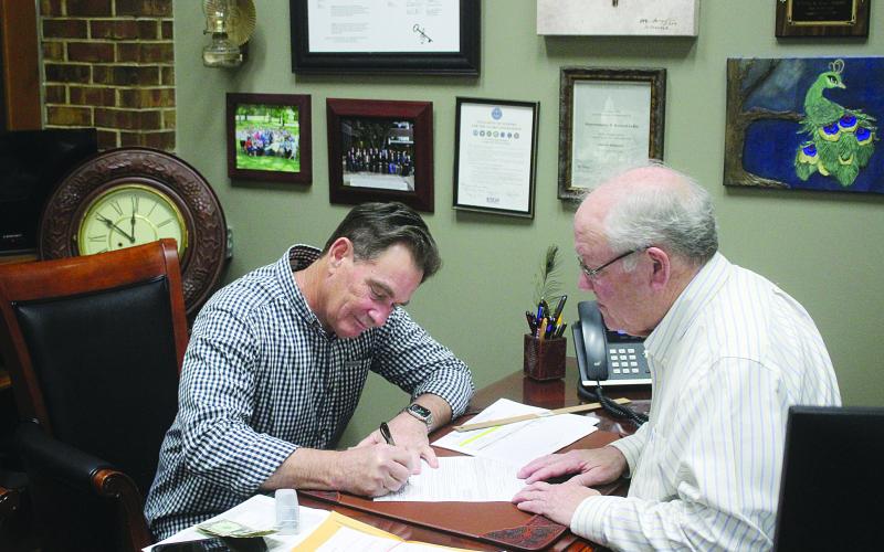 Donald Bergeron (left) is pictured as he qualifies for Evangeline Parish School Board District 10. Also pictured is Clerk of  Court Randy Deshotel (right). (Gazette photo by Tony Marks)