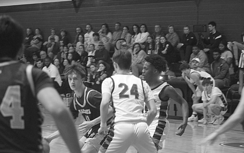 Zac Fontenot (11) looks to go through traffic on the basketball court in Sacred Heart’s road loss at Reeves. (Gazette photo by Tony Marks)