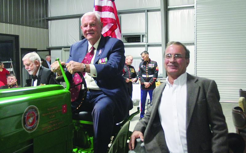 Major General Ronald J. Richard sits atop his grandfather’s tractor that was restored by Tom Klumpp (right) owner of Klumpp Equipment on the Basile Eunice Highway. Klumpp was one of the hosts for a Marine Corps Birthday Ball held Wednesday, November 10, that celebrated the 246th birthday of the United States Marine Corps. (Gazette photo by Tony Marks)