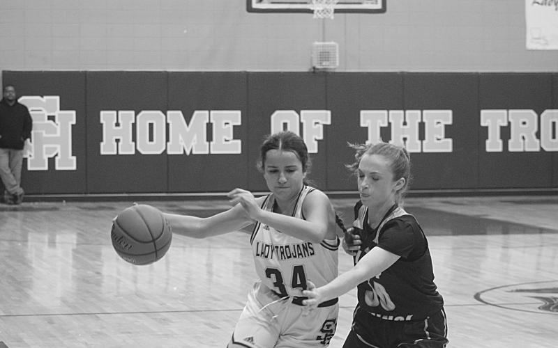 Sacred Heart’s Riley St. Cyr (34) moves the ball down the court in the Lady Trojans game against Opelousas Catholic earlier this season. The team now has a first-round bye in the playoffs. (Gazette photo by Tony Marks)