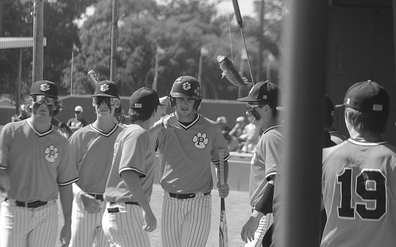Members of the Pine Prairie baseball team celebrate with Benny the Bass after Cayden McCollough (2) scores the lone Panther run in the top of the first inning of Game 1 against Rosepine on Friday, April 28. (Gazette photo by Tony Marks)