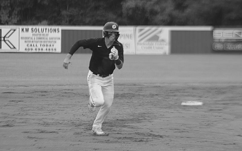 Grant Welch (5) hustles around the bases on his way to score in Game 3. (Gazette photo by Tony Marks)