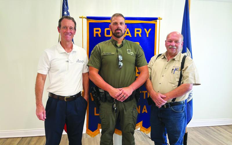 CHANGES IN HUNTING AND FISHING REGULATIONS DISCUSSED -  Corporal Mike Darbonne with the LDWF (center) shared several changes  to the 2024-2025 state hunting and fishing regulations. He is shown with Rotarian Richard LeJeune (left) and Rotary President Bob Manuel (right). (Gazette photo by Heather Bogard)