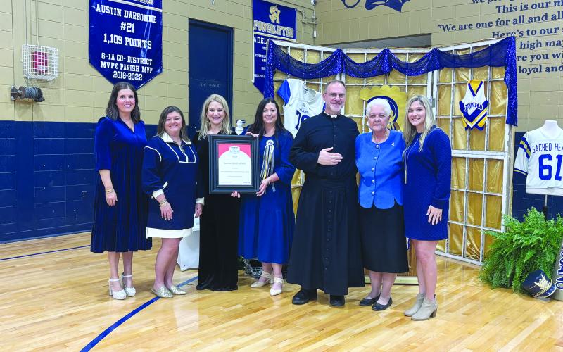 PRESTIGIOUS AWARD PRESENTED - During homecoming festivities on Friday, November 7, Sacred Heart School received the Cognia School of Distinction honor. Shown, from left, are Kylie LaHaye, high school curriculum coordinator; Jodi Andrus, elementary curriculum coordinator; Dawn Shipp, high school principal; Danielle Ardoin, elementary principal; Father Mitchell Guidry, pastor; Anna Larriviere, Superintendent of the Diocese of Lafayette Catholic Schools; and Sadie Fontenot, high school guidance counselor.