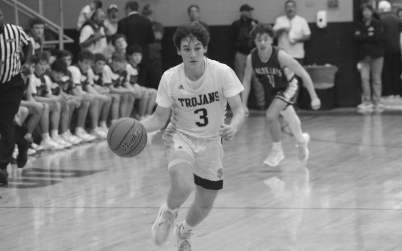 Gabe Fontenot (3) scored 10 points for the Sacred Heart Trojans in their district win over St. Edmund Tuesday night at home. Hayden Deshotel led the team with 19 points. (Gazette photo by Rhett Manuel)