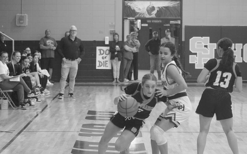 Pine Prairie’s Josie Vidrine (3) dribbles around Sacred Heart’s Riley St. Cyr (34) in the Lady Panthers’ 62-52 loss to the Lady Trojans on Tuesday night. (Gazette photo by Tony Marks)