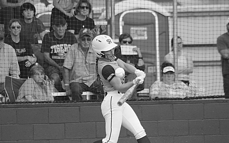 Lady Trojan Ava Johnson connects with a pitch in a game against Sam Houston at home. (Gazette photo by Rhett Manuel)