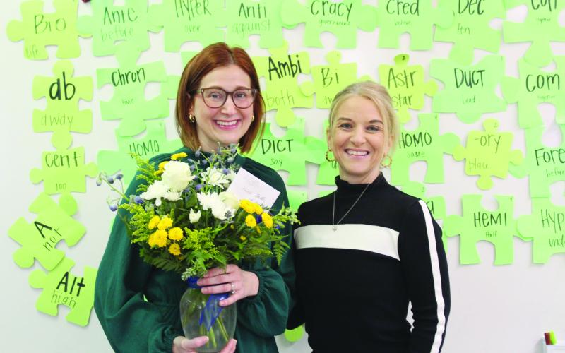 Sacred Heart High School Principal Dawn Shipp (right) presents flowers to the school’s teacher of the year, Kaitlin Deville (left). (Photos courtesy of Kimberly LeJeune)