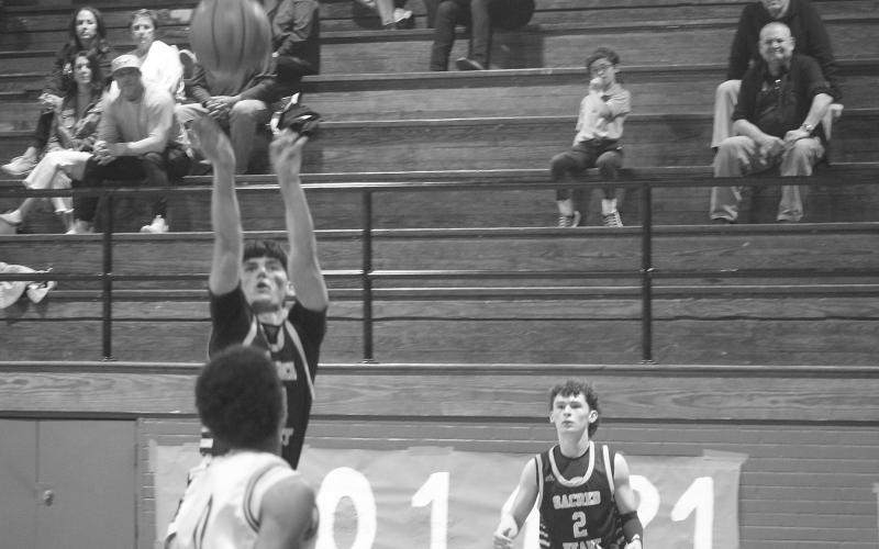 In his last game wearing the Sacred Heart basketball uniform, Seth Guillory (34) attempts a basket in the Trojans’ 58-33 loss to Opelousas Catholic in the first round of the playoffs. (Gazette photo by Tony Marks)