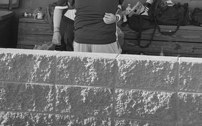A tearful Hayden Fontenot gets consoled in the Trojan dugout after his team dropped Game 3 of the best-of-three series against Ouachita Christian on Saturday, May 7.  (Gazette photo by Rhett Manuel)