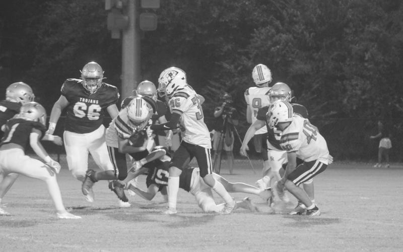 Sacred Heart’s Sully Manuel (13) makes a diving tackle on Pine Prairie’s Rhett Guillory (33) in the Trojans’ 42-0 win over the Panthers. (Gazette photo by Tony Marks)