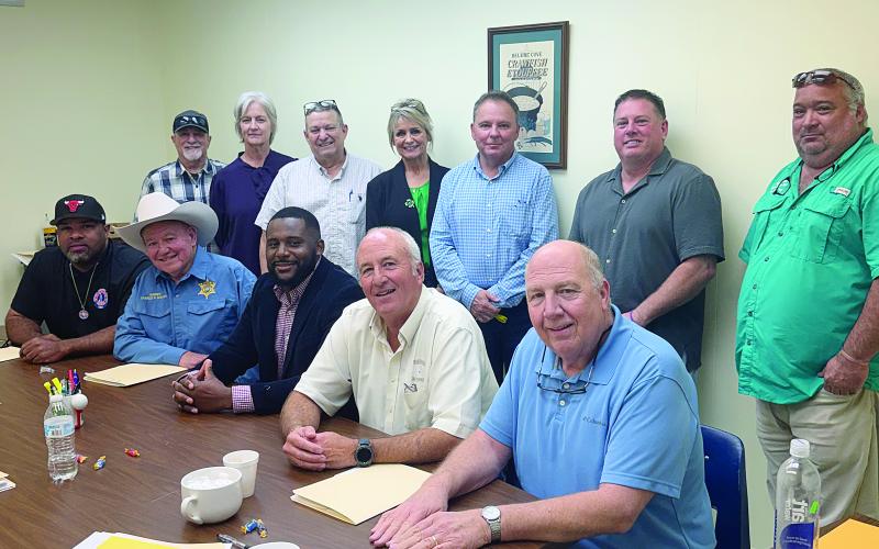 From left are (standing) Turkey Creek Mayor Bert Campbell, Evangeline Parish School Board member Karen Vidrine, Evangeline Parish Secretary-Treasurer Dirk Deville, Mamou Mayor Leisa Deshotel, Pine Prairie Mayor Quint West, Basile Mayor Mark Denette, and Chataignier Mayor Justin Darbonne; (sitting) Ville Platte Mayor Ryan LeDay Williams, Evangeline Parish Sheriff Charles Guillory, incoming administrator Cody Jones, outgoing administrator Marty Morein, and Evangeline Solid Waste Commission Executive Director