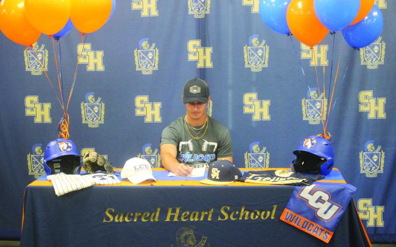 Sam Veillon, formerly of Sacred Heart, is pictured as he signs to play baseball at Louisiana Christian University during a  ceremony held Wednesday, July 2. (Gazette photo by Tony Marks)