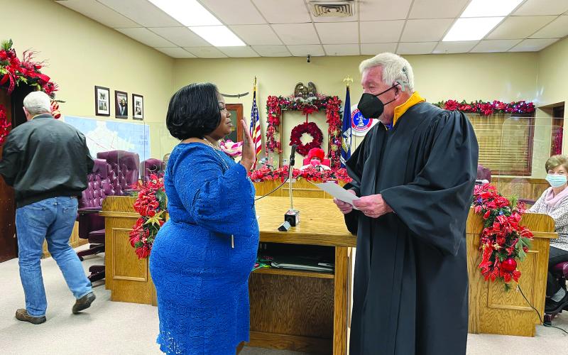 SAM SWORN IN - Judge John Larry Vidrine, right, administers the oath of office to Christina Sam, new Ville Platte City Council member representing District E. She is taking the place of her late husband, Donald Sam. (Gazette photo by Heather Bogard)