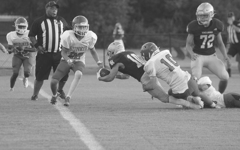 Trojan workhorse Blake Hebert (10) dives across the goaline for a Sacred Heart touchdown in a scrimmage against Bunkie held Friday, August 19. The team now takes on Pine Prairie in the Evangeline Parish Jamboree tomorrow night. (Gazette photo by Tony Marks)