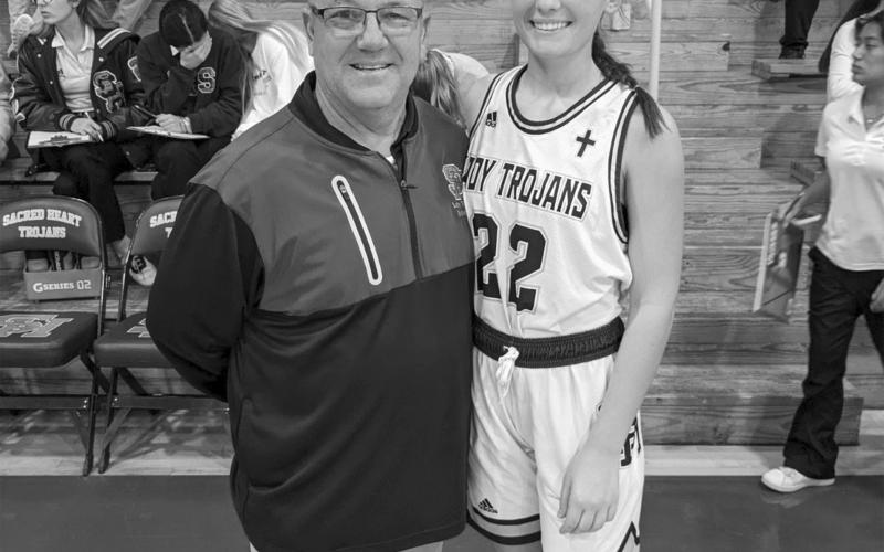 Kali Shiver (right) is pictured with her head coach Craig Whittington (left) after collecting the 1 thousandth point of her career as a Sacred Heart Lady Trojan. (Gazette photo by Rhett Manuel)