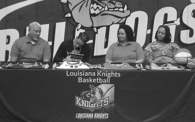 Sage Papillion (second from left) is pictured as he signs to play with the Louisiana Knights, which is a post grad academy. Also pictured (from left) are Nick Papillion, Shamika Papillion, and Jonah Papillion. (Photos courtesy of Todd Ardoin and by Tony Marks)