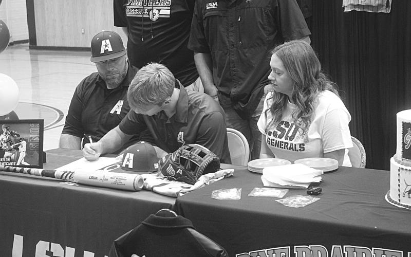 Braylon Fontenot (center), of Pine Prairie High School, is pictured as he signs to play baseball at LSUA. Pictured on the left is his father, Taylor, and on the right is his mother, Kelly. (Gazette photo by Tony Marks)