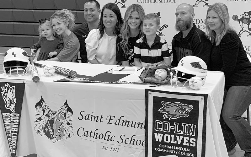 Flanked by her family and head coach Nick Trosclair, Vidrine native Karleigh Soileau signs a National Letter of Intent to play softball for Copiah-Lincoln Community College. (Gazette photo by Rhett Manuel)