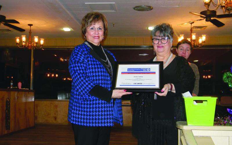 Sonia Ardoin, board member on the St. Landry-Evangeline United Way, (left)was honored as Board Member of the Year during the annual appreciation banquet held Monday, January 24, at Toby’s Lounge and Reception Hall in Opelousas. She is shown with Executive Director Ginger LeCompte. Standing behind LeCompte is Dori Comeaux, Community Outreach Director. (Gazette photo by Heather Bogard)