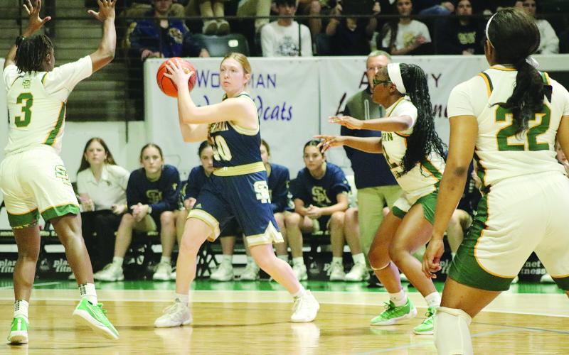 Rose Ardoin (40) looks to pass the ball to a fellow Lady Trojan in the state semifinals.