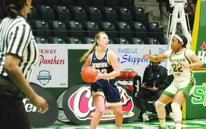 Jodie Landry (23) prepares to inbound the basketball while being guarded by a Lady Kitten.