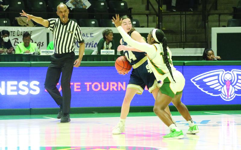 Jodie Landry (23) prepares to inbound the basketball while being guarded by a Lady Kitten.