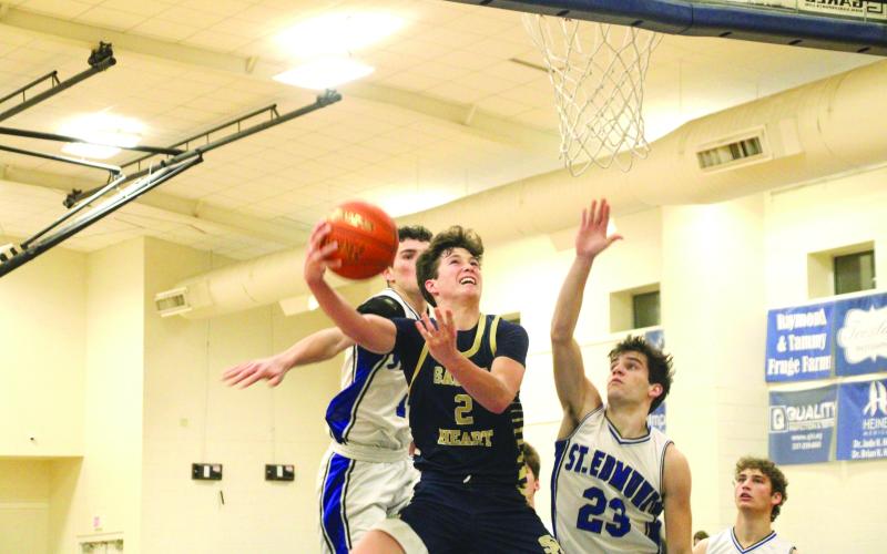 Sacred Heart guard Ellis Chapman goes up for a layup in last Friday’s 60-44 win over St. Edmund. The Trojan boys and girls split their games with the Blue Jays in District 5-1A play. (LSN Photo by Rhett Manuel)
