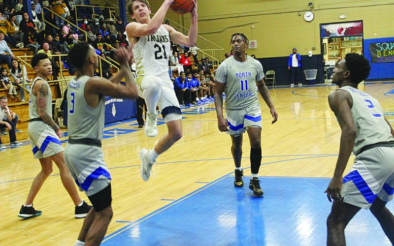 Austin Darbonne (21) goes for a basket against North Central. In the game against the Hurricanes, he recorded his 1,000th career point. (Gazette photo by Rhett Manuel)