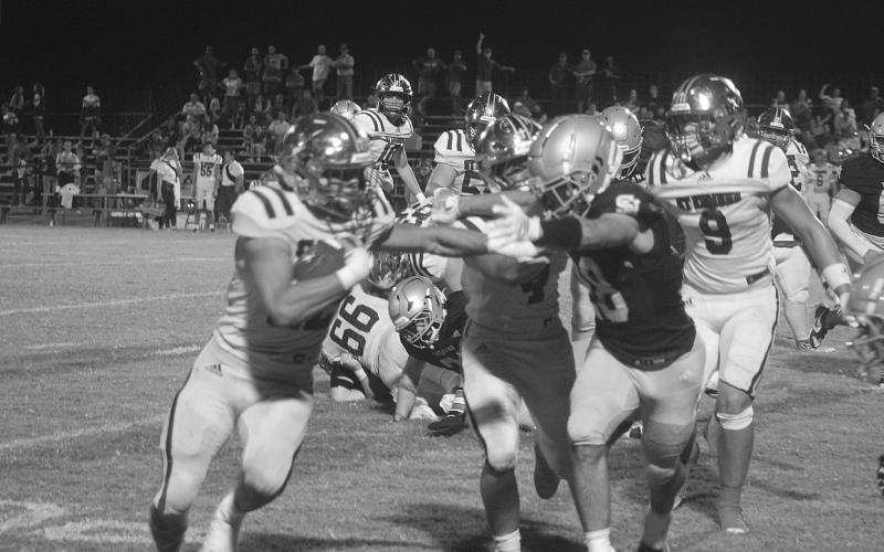 Drew Mayeaux (28) tries to force a St. Edmund ball carrier out of bounds in Sacred Heart’s 58-36 home loss last Friday. (Gazette photo by Tony Marks)