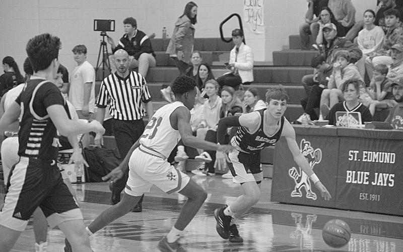 Elliot Fontenot (1) drives down the court past a Lacassine defender in Sacred Heart’s 74-48 loss in the finals of the Kendall and Brad Fontenot Memorial Shootout. (LSN photo by Rhett Manuel)