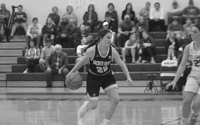 Alyssa Brignac (20) drives toward the basket against St. Edmund’s Tuesday night as Sacred Heart earned a 64-59 win. (Gazette photo by Rhett Manuel)