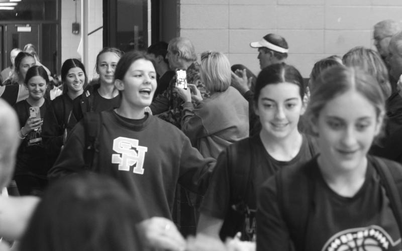 The Sacred Heart Lady Trojans are treated to a hero’s welcome as they return to the Halls of Troy after winning the District 6-1A championship on Tuesday night. (Gazette photo by Rhett Manuel)