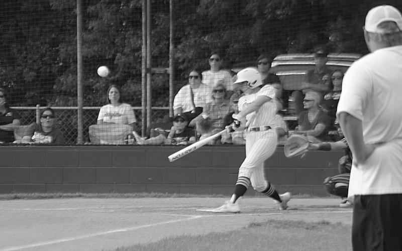 Sacred Heart flex player Jenna Veillon (6) connects with a pitch in the Lady Trojans’ 11-1 win over St. John in the second round of the Division IV Select softball playoffs. (Gazette photo by Rhett Manuel)