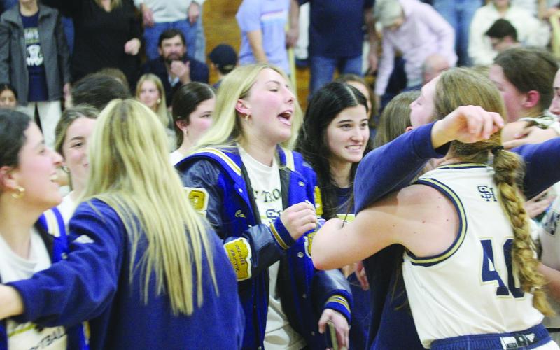 Members of the Sacred Heart Lady Trojan basketball team, including Taylor Darbonne, Olivia Tate, Ava Johnson, and Rose Ardoin, celebrate after advancing to the state semi-finals in Hammond. (Gazette photos by Rhett Manuel)