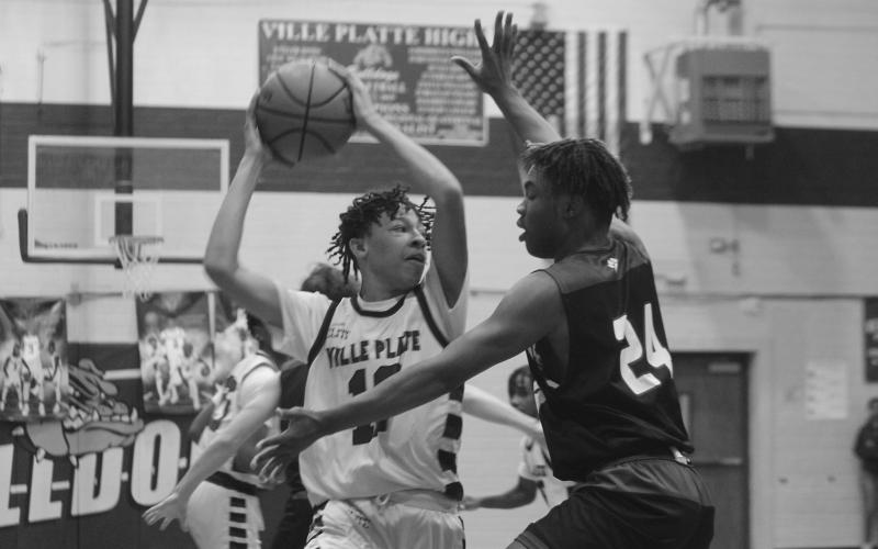 Jaden Jacobs looks to pass the basketball in Ville Platte High’s playoff loss to Sterlington. (Gazette photo by Rhett Manuel)