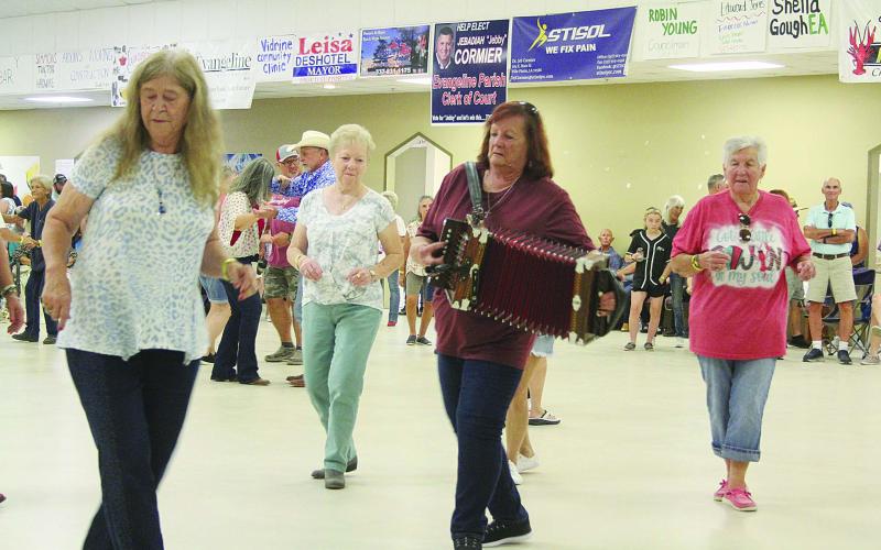 In the bottom photo, Sheryl Cormier line dances while performing with Cajun Sounds. (Gazette photos by Tony Marks)