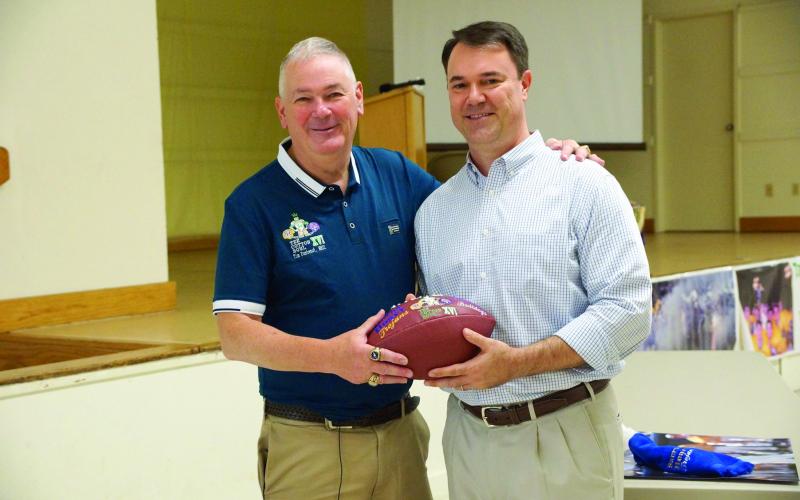 Man of the Year Tim Fontenot (left) is pictured as he gives a Tee Cotton Bowl game ball to LSU Baseball hero Warren Morris. (Gazette file photo)